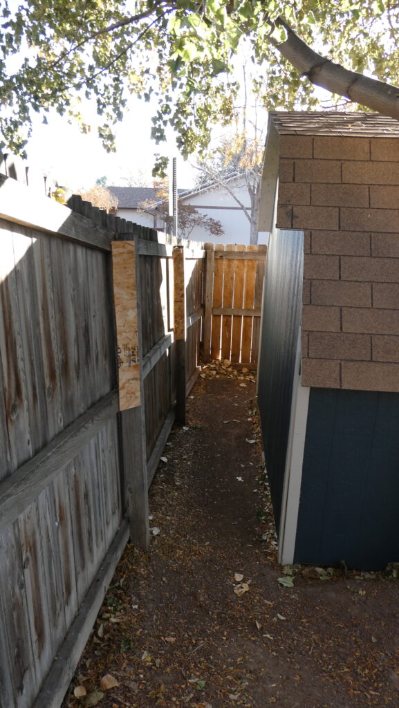 Wood shed fence narrow passage